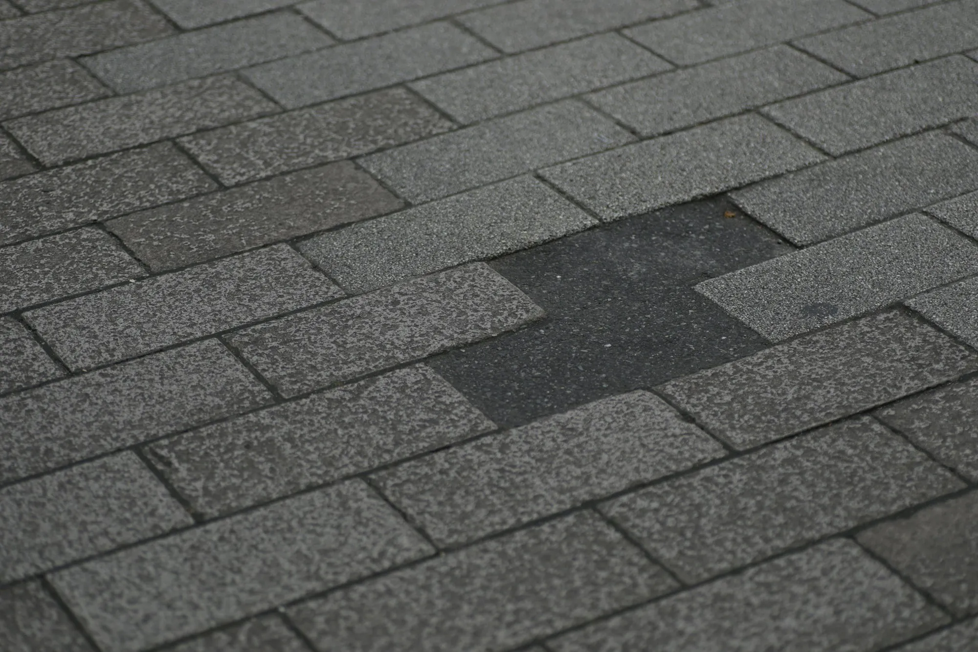Asphalt shingle roof with shingles missing from the slope