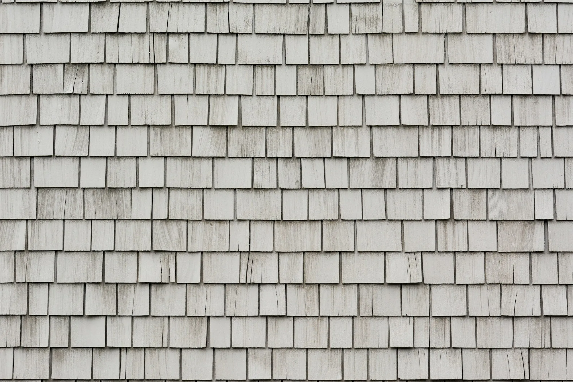 Close view of weathered wood shingle courses